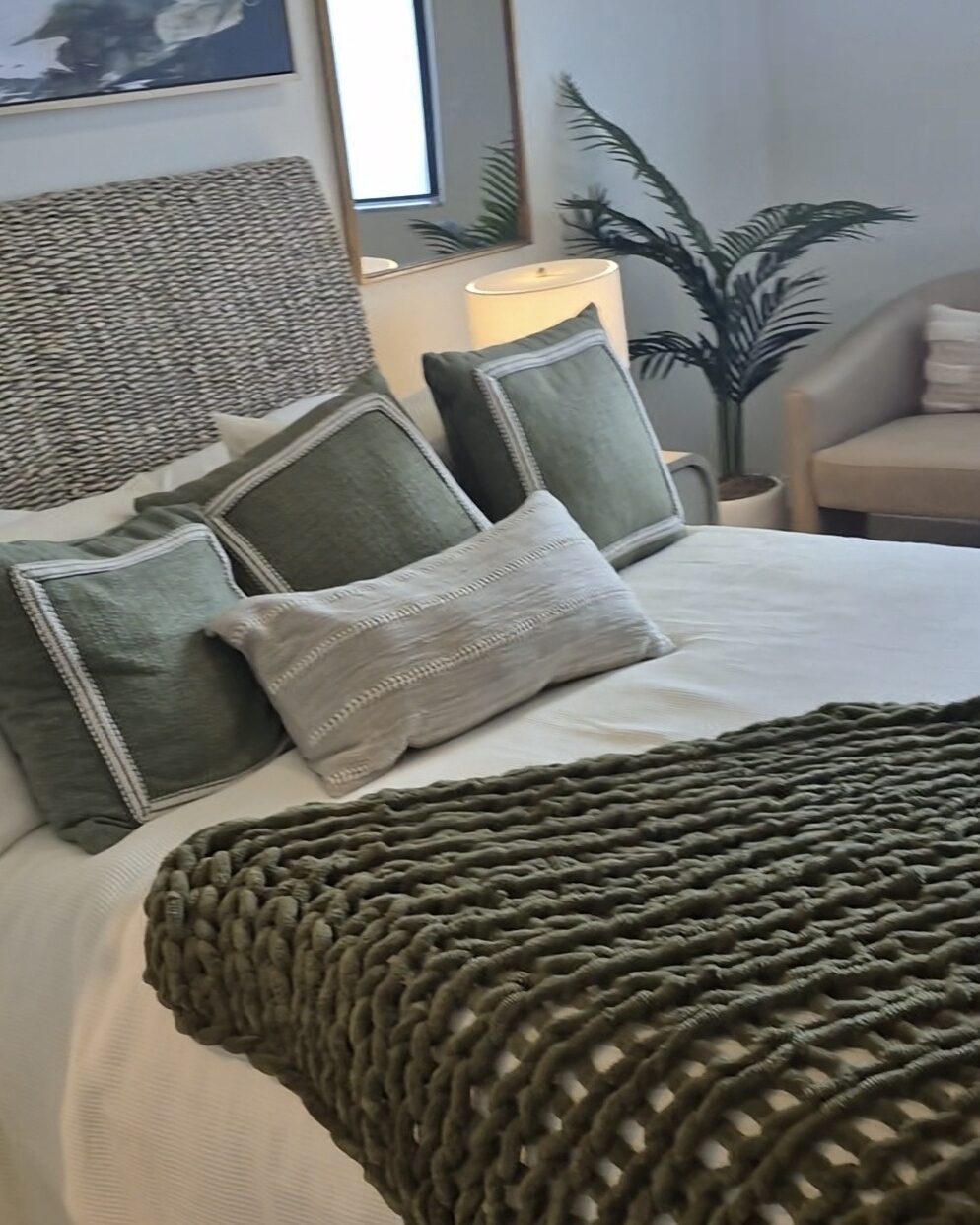 Cleaned bedroom with a freshly made bed and pillows