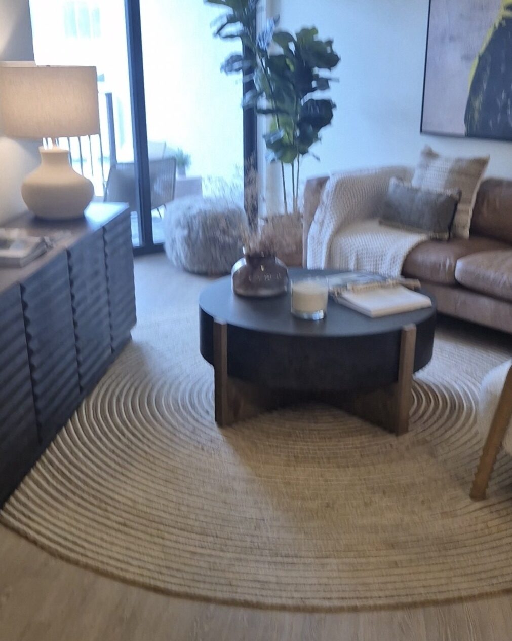 Freshly cleaned living room with a round rug and coffee table